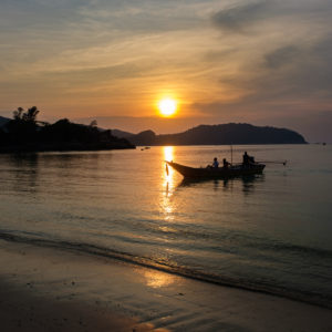 Water taxi komt aan tijdens zonsondergang bij Coconut Bay